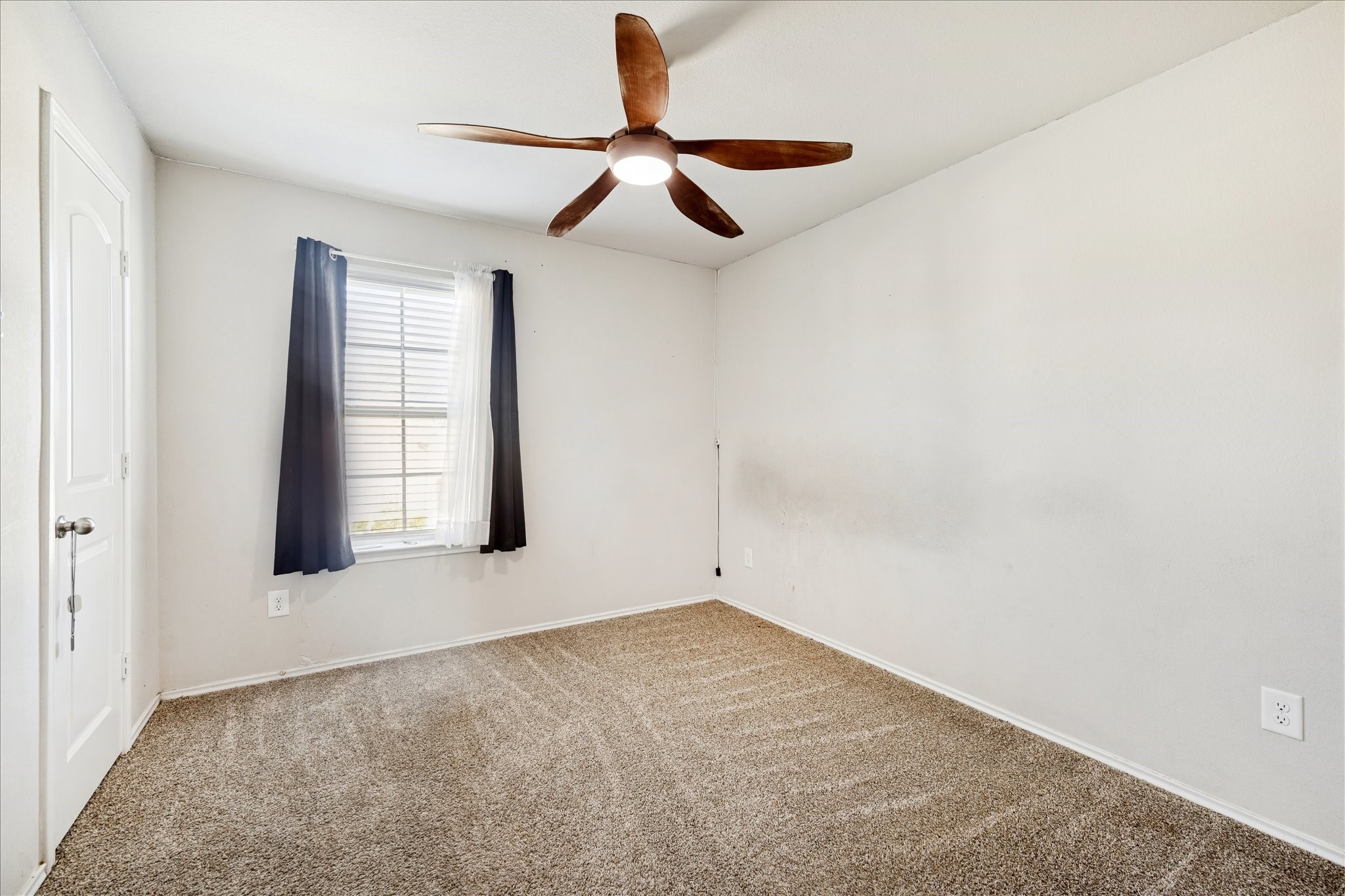 23703 Harrow Field Ln Spring Spring, TX 77373 - Photo 7 of 9 an empty room with windows and fan