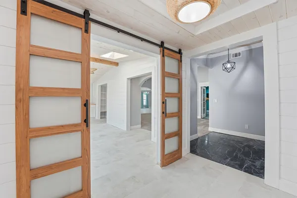 a bedroom with a large bed and ceiling fan