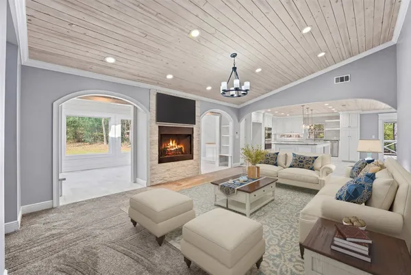 a living room with furniture and a chandelier