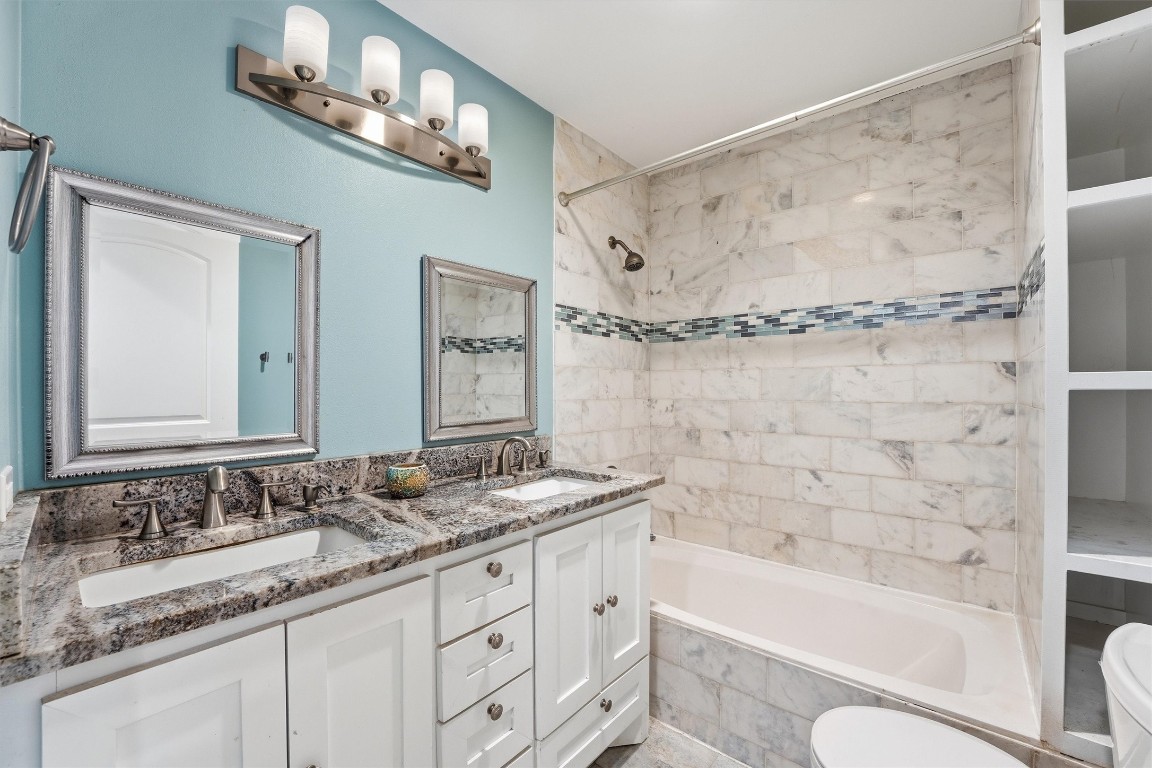 2920 Superior Road Magnolia, TX 77354 - Photo 25 of 46 a bathroom with a granite countertop sink a toilet and bathtub