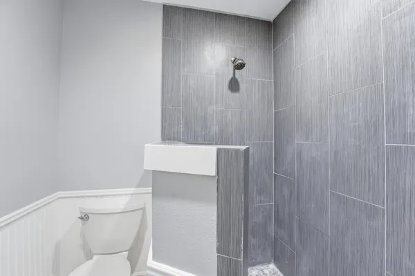 a spacious bedroom with a bed and a flat screen tv