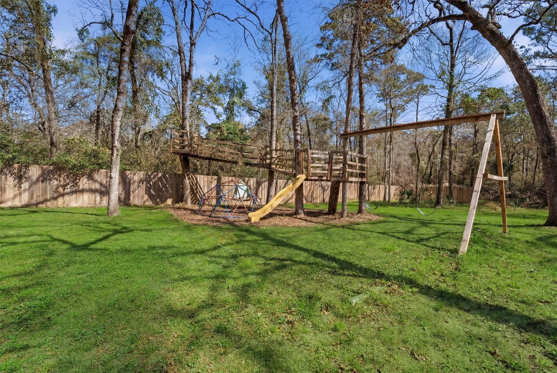 2920 Superior Road Magnolia, TX 77354 - Photo 37 of 46 a view of backyard with a slide