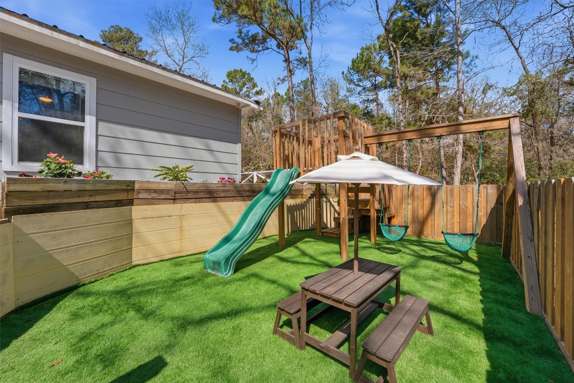 2920 Superior Road Magnolia, TX 77354 - Photo 38 of 46 a backyard of a house with barbeque oven table and chairs