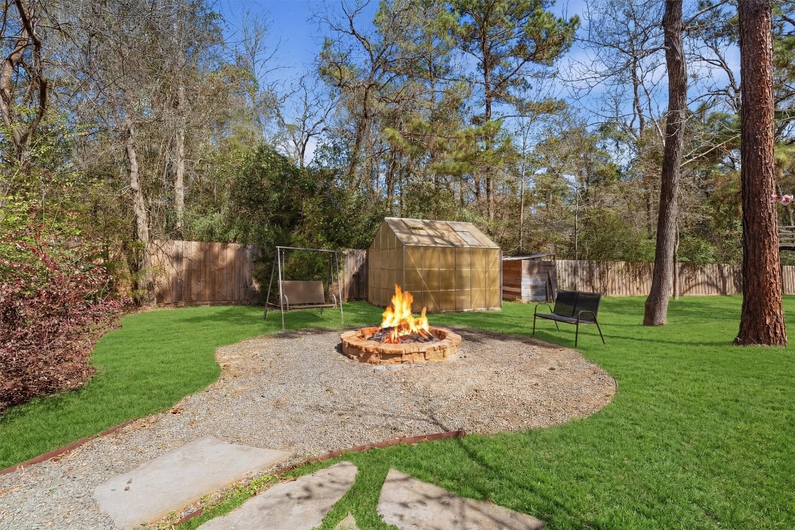 2920 Superior Road Magnolia, TX 77354 - Photo 40 of 46 a backyard of a house with a garden and outdoor seating