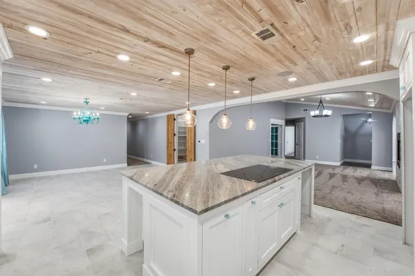 a kitchen with granite countertop a sink and a counter top space