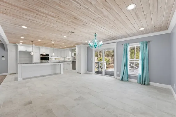 a view of a kitchen with white cabinets and a wooden floor