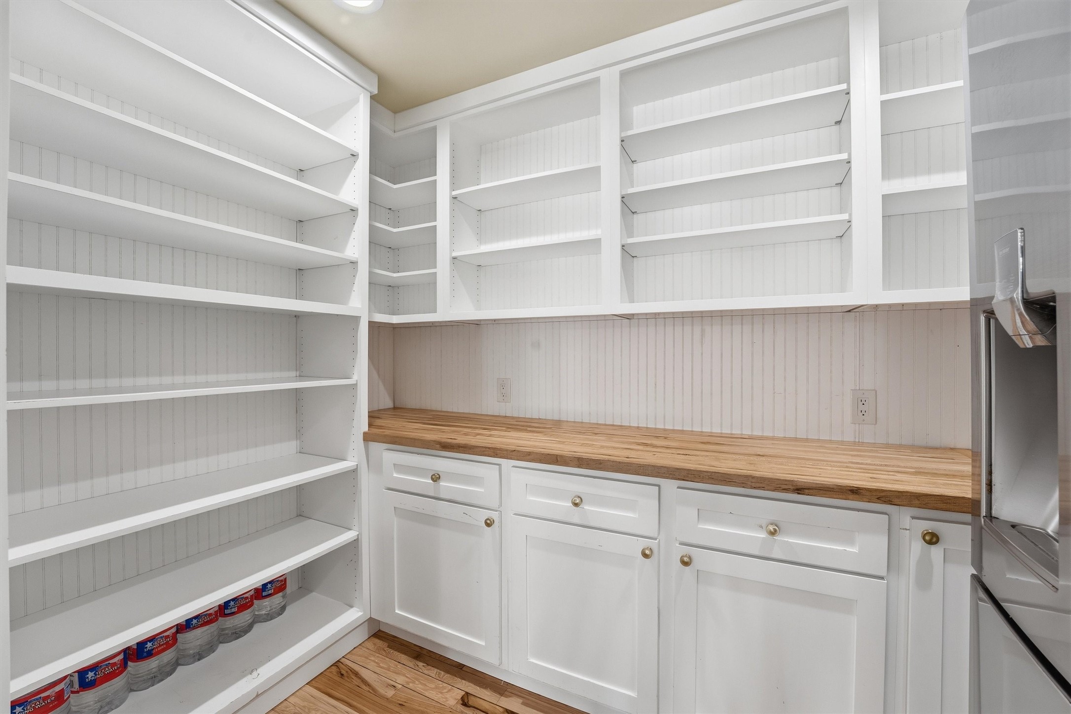 2920 Superior Road Magnolia, TX 77354 - Photo 8 of 46 a view of a kitchen with white cabinets and a wooden floor