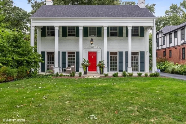 a view of a house with garden and porch