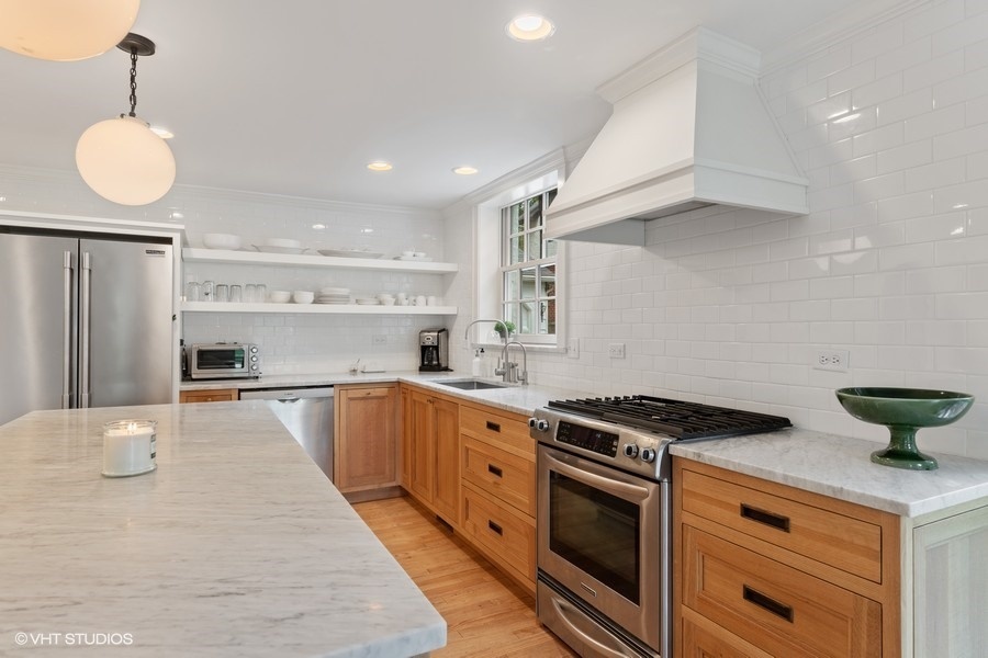 162 Maplewood Road Riverside, IL 60546 - Photo 16 of 44 a large kitchen with stainless steel appliances granite countertop a stove a sink and white cabinets with wooden floor
