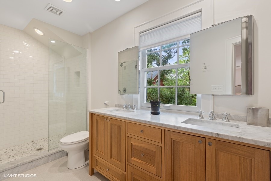 162 Maplewood Road Riverside, IL 60546 - Photo 31 of 44 a bathroom with a granite countertop sink toilet a large mirror a shower and a bathtub