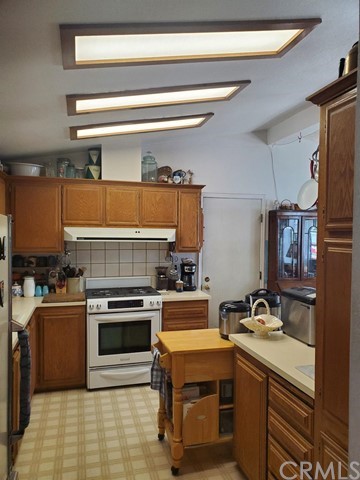 12285 Golden View Road Pinon Hills, CA 92372 - Photo 15 of 33 a kitchen with a stove and a sink