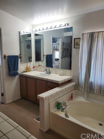 12285 Golden View Road Pinon Hills, CA 92372 - Photo 21 of 33 a bathroom with a tub sink and mirror