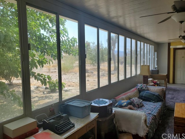 12285 Golden View Road Pinon Hills, CA 92372 - Photo 28 of 33 a living room with furniture and a floor to ceiling window