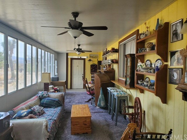 12285 Golden View Road Pinon Hills, CA 92372 - Photo 29 of 33 a living room with furniture a ceiling fan and a window