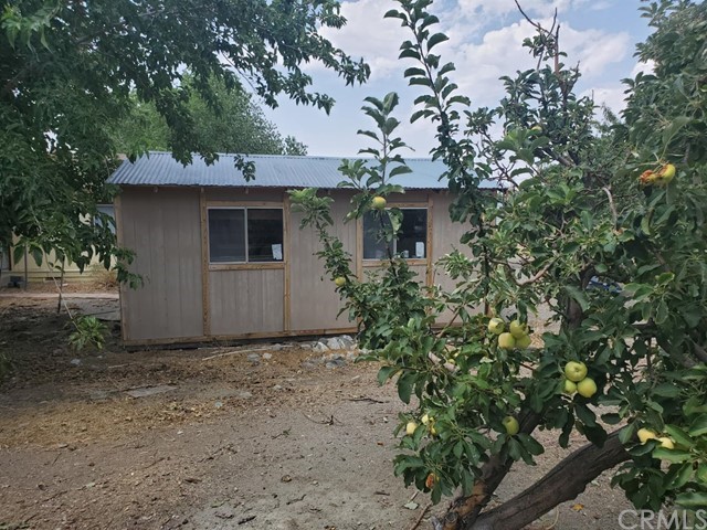 12285 Golden View Road Pinon Hills, CA 92372 - Photo 10 of 33 a view of a house with a tree