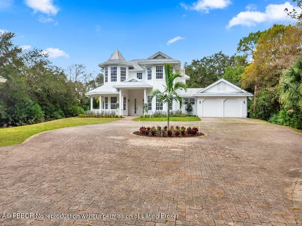 a front view of a house with a yard and lake view