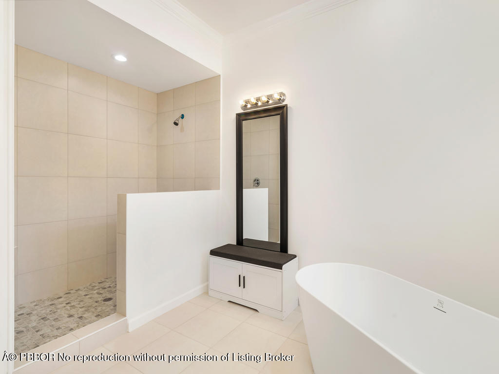 1001 Southeast Ranch Road Northeast Jupiter, FL 33478 - Photo 16 of 32 a bathroom with a bathtub and a sink