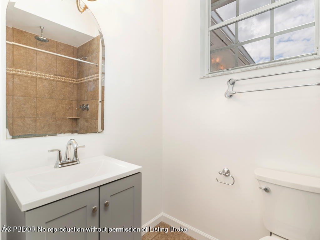 1001 Southeast Ranch Road Northeast Jupiter, FL 33478 - Photo 18 of 32 a bathroom with a sink and a mirror