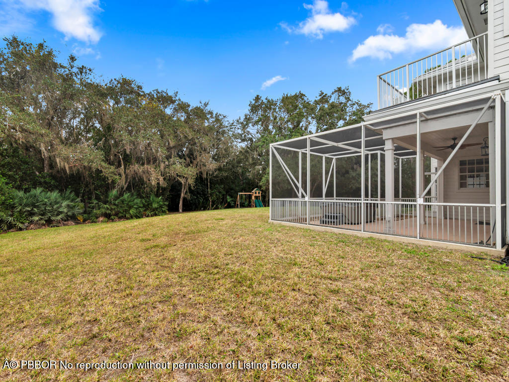 1001 Southeast Ranch Road Northeast Jupiter, FL 33478 - Photo 22 of 32 a view of a backyard with floor to ceiling window and tree