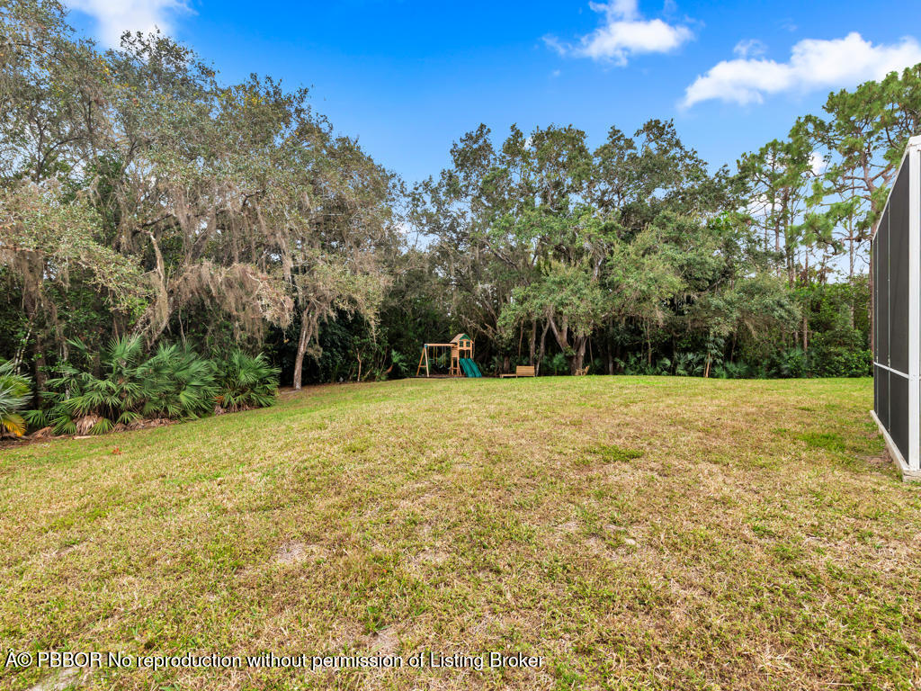 1001 Southeast Ranch Road Northeast Jupiter, FL 33478 - Photo 25 of 32 a view of a yard with trees in the background