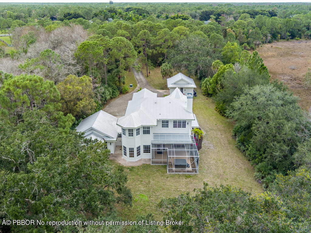 1001 Southeast Ranch Road Northeast Jupiter, FL 33478 - Photo 28 of 32 an aerial view of a house with a yard