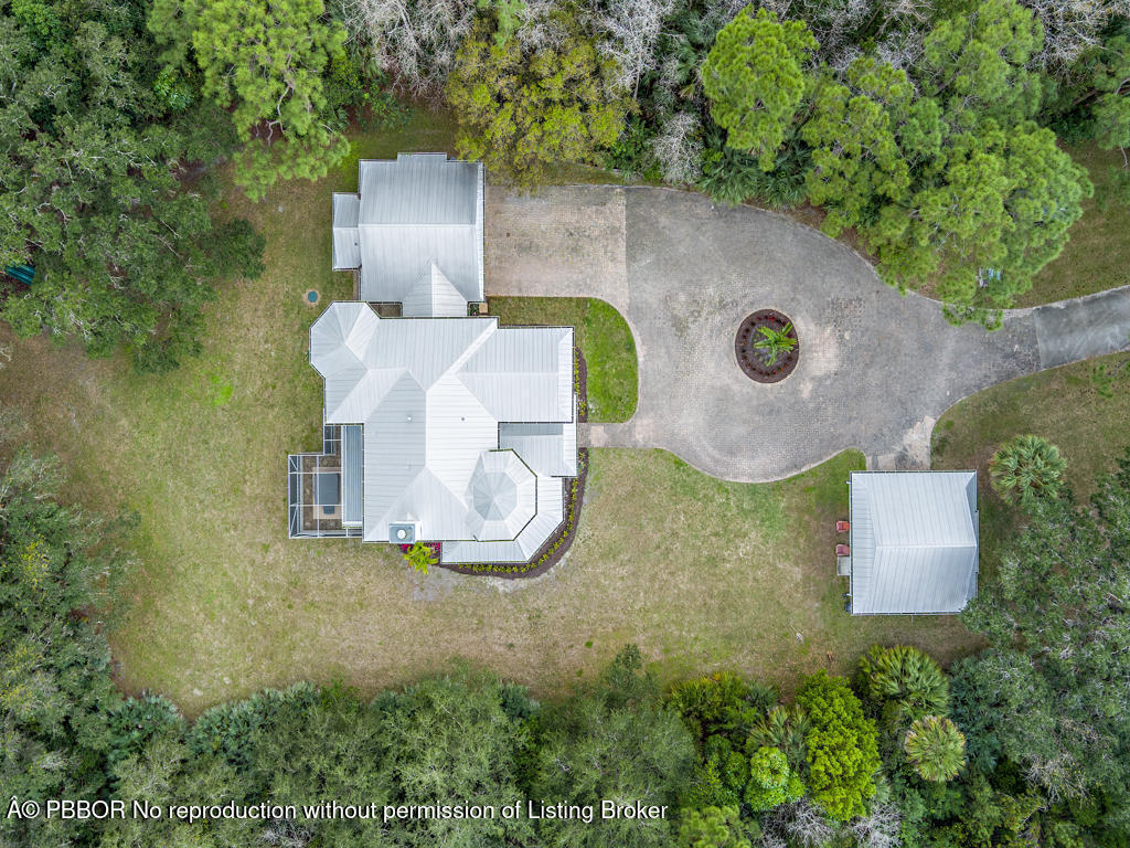 1001 Southeast Ranch Road Northeast Jupiter, FL 33478 - Photo 29 of 32 an aerial view of a house with a yard and garden