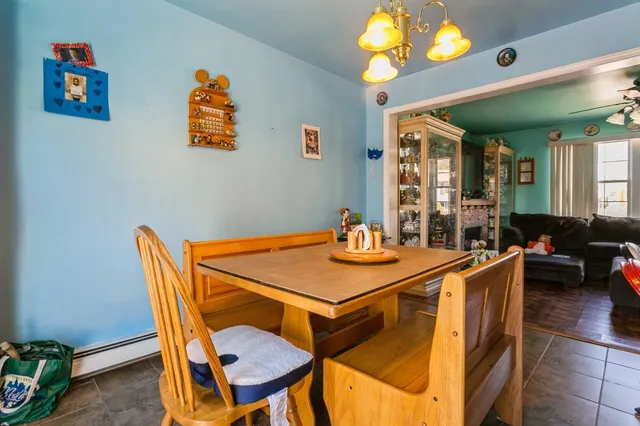 a view of a dining room with furniture and a chandelier
