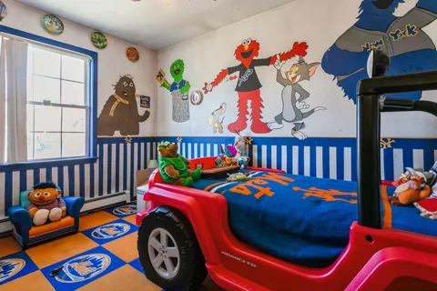 a kids room with a bed and toys