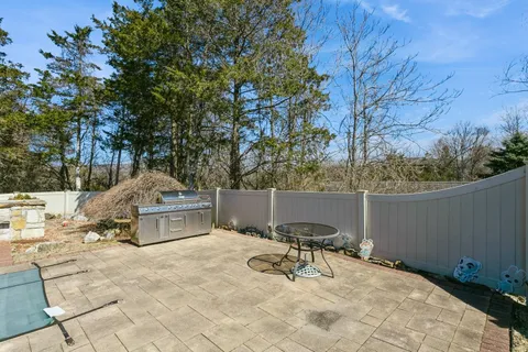 a view of backyard with a table and chairs