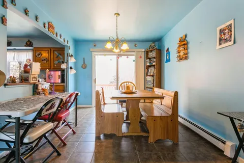 a view of a dining room with furniture and chandelier