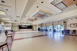 a room with furniture pool table and window