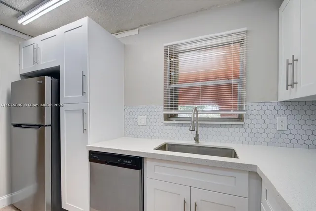 a kitchen with a sink and a refrigerator