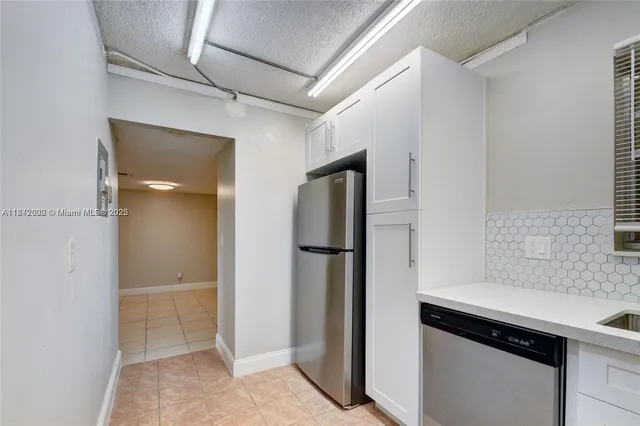a kitchen with a refrigerator and a sink