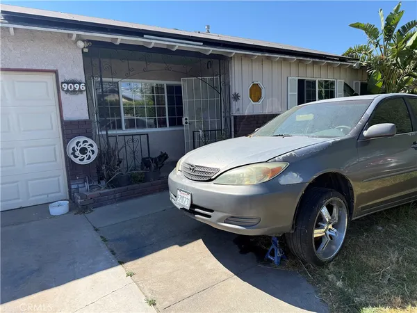 a front view of a house with parking space