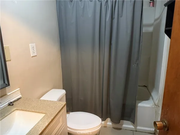 a white toilet sitting next to a bathroom sink