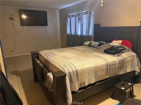 a bedroom with a bed and a mirror