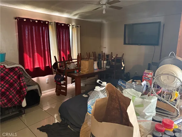 a living room with furniture a flat screen tv and a window