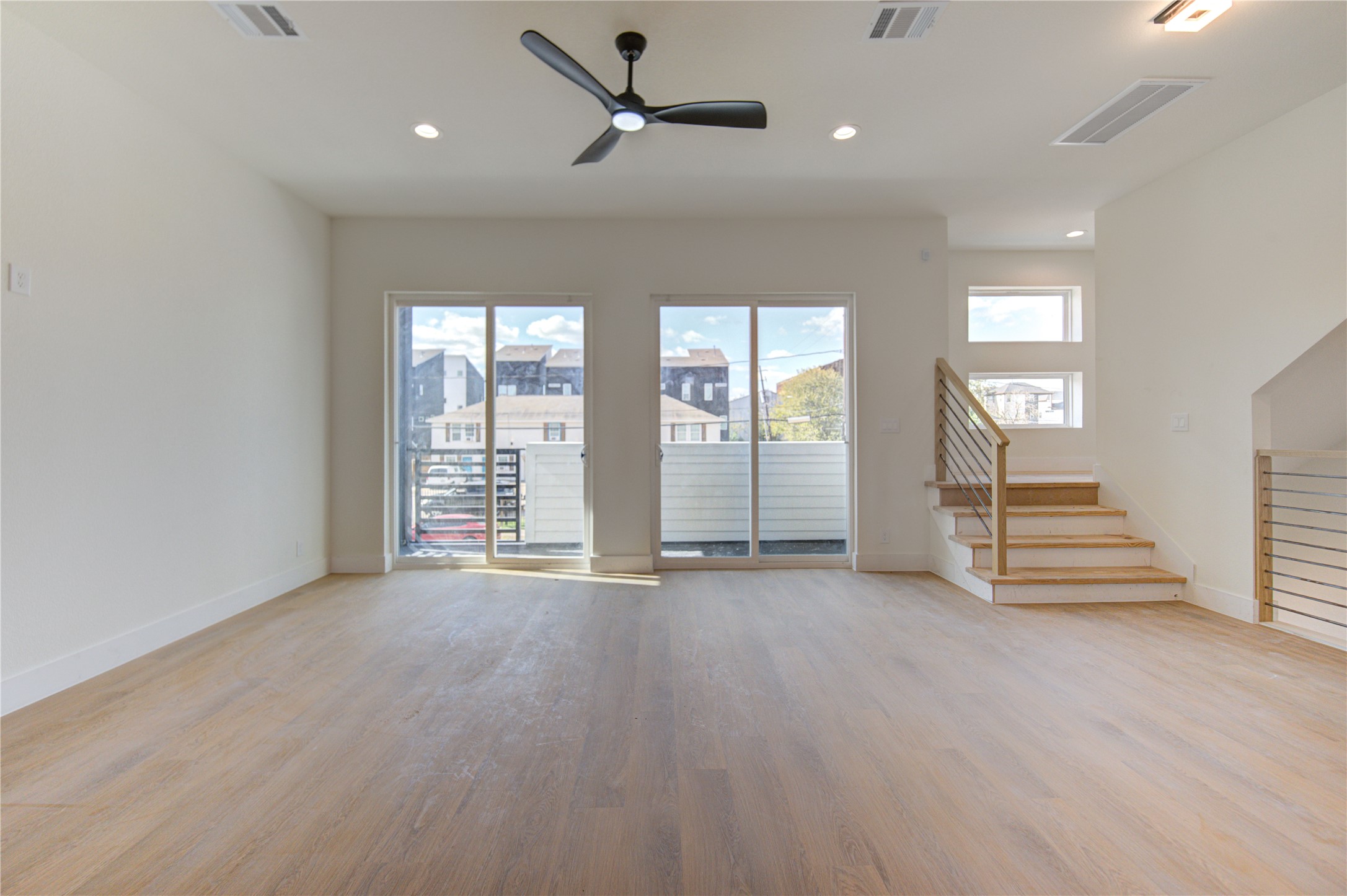 4702 Coke Street Houston, TX 77020 - Photo 12 of 35 an empty room with wooden floor and windows