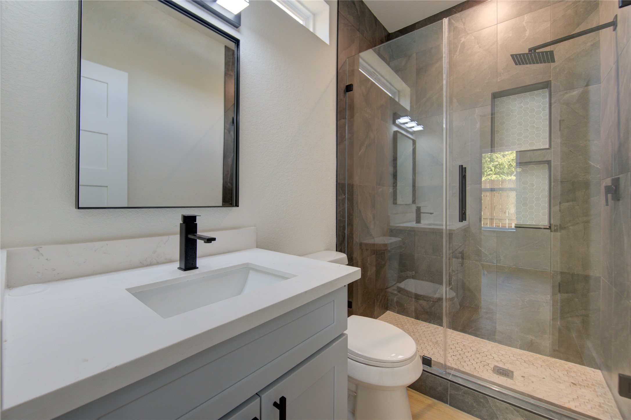4702 Coke Street Houston, TX 77020 - Photo 25 of 35 a bathroom with a sink a toilet and shower