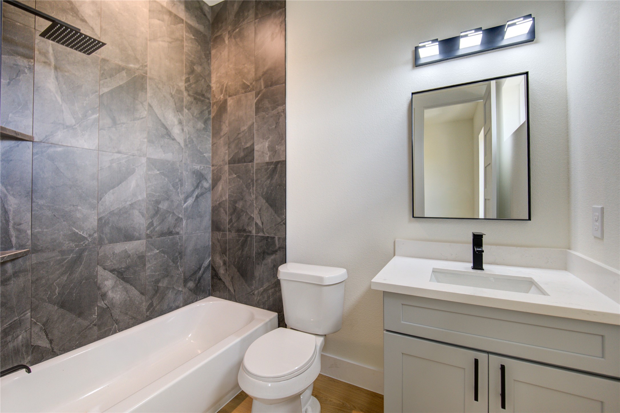 4702 Coke Street Houston, TX 77020 - Photo 26 of 35 a bathroom with a toilet a sink and bathtub
