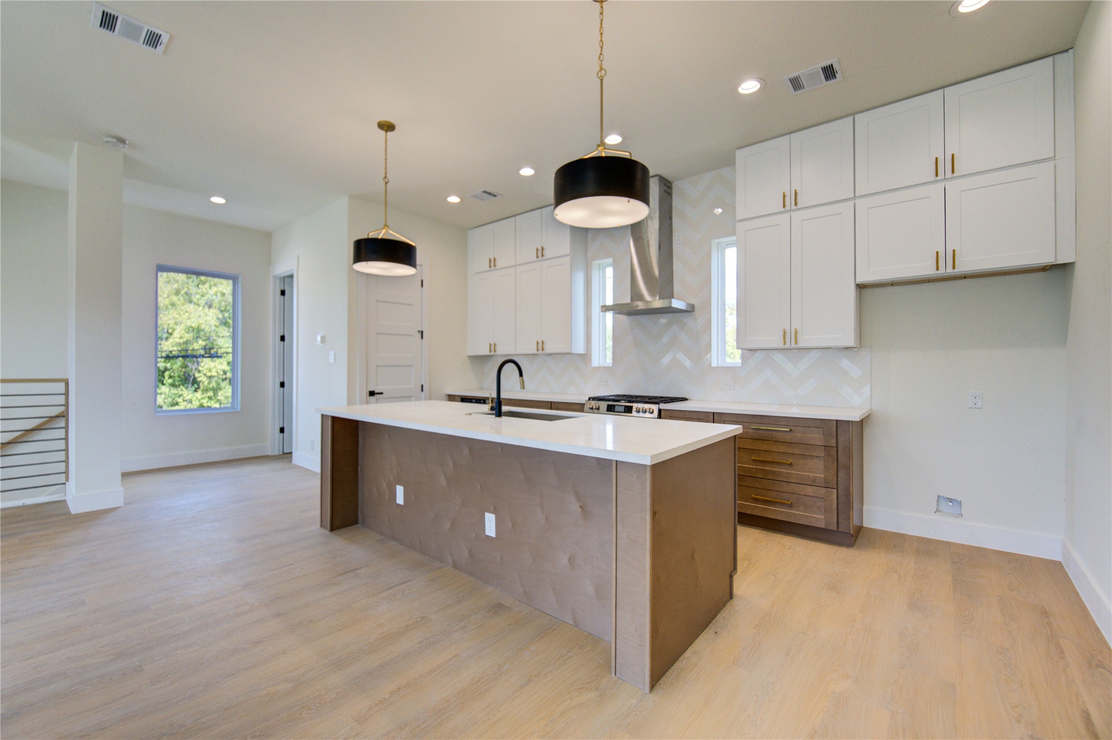 4702 Coke Street Houston, TX 77020 - Photo 7 of 35 a large kitchen with kitchen island a sink stainless steel appliances and cabinets