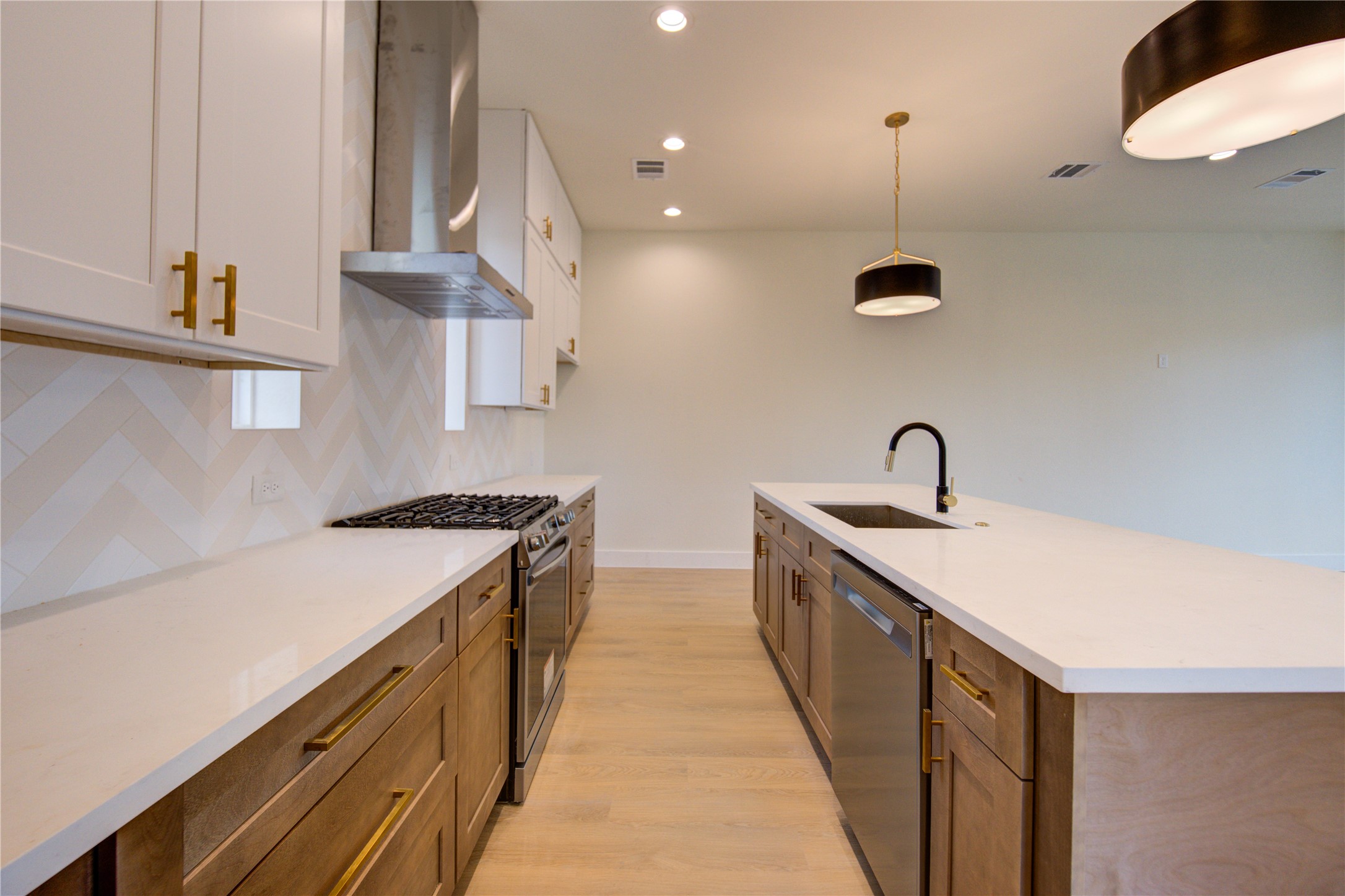 4702 Coke Street Houston, TX 77020 - Photo 9 of 35 a kitchen with a sink a stove and a wooden floor