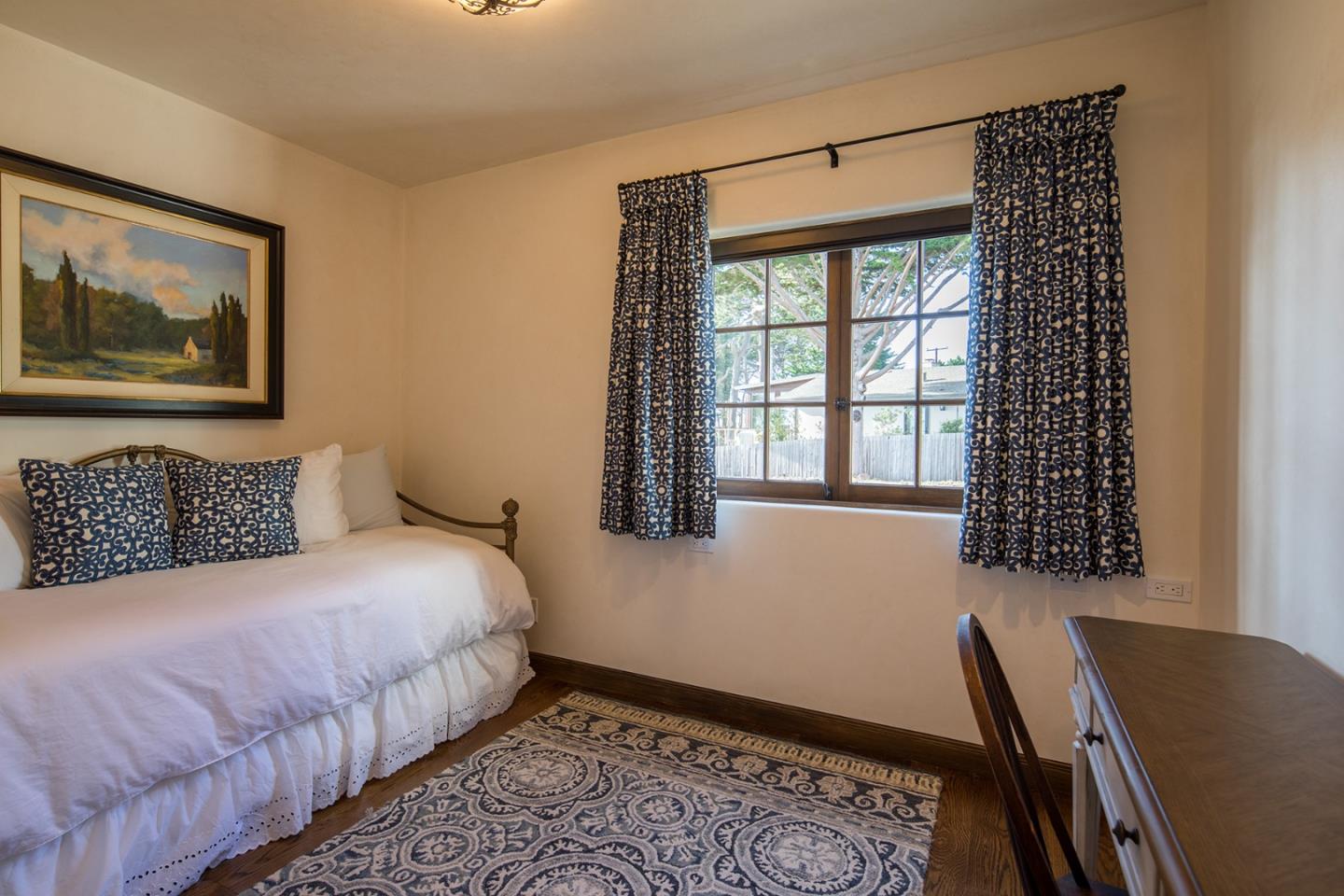 1011 Rodeo Road Pebble Beach, CA 93953 - Photo 12 of 41 a bedroom with a bed and a window