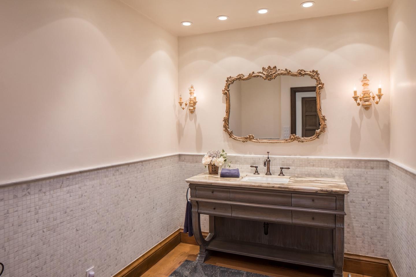 1011 Rodeo Road Pebble Beach, CA 93953 - Photo 23 of 41 a bathroom with a sink and a mirror