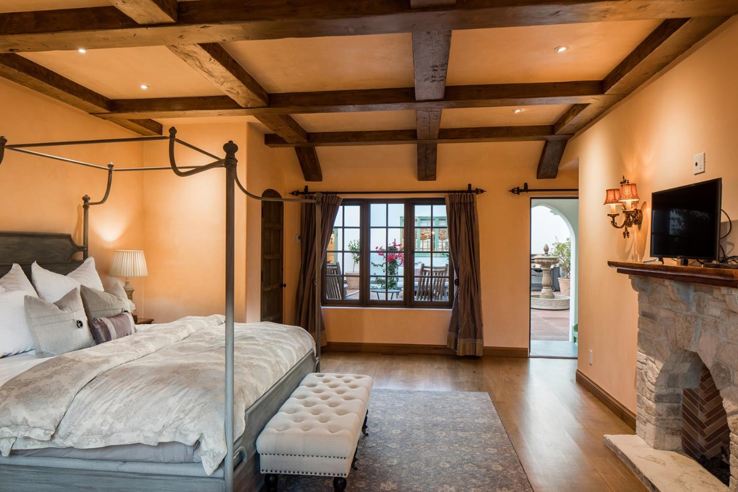 1011 Rodeo Road Pebble Beach, CA 93953 - Photo 24 of 41 a bedroom with a bed and a television