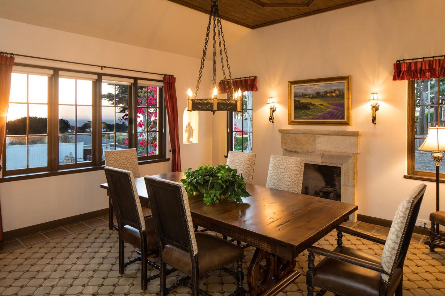 1011 Rodeo Road Pebble Beach, CA 93953 - Photo 4 of 41 a dining room with furniture a chandelier and wooden floor