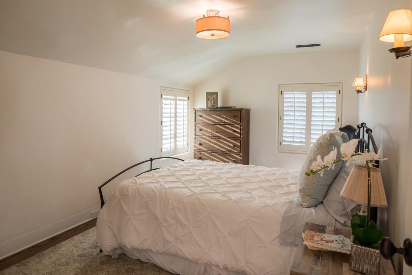1011 Rodeo Road Pebble Beach, CA 93953 - Photo 32 of 41 a bedroom with a bed and a window