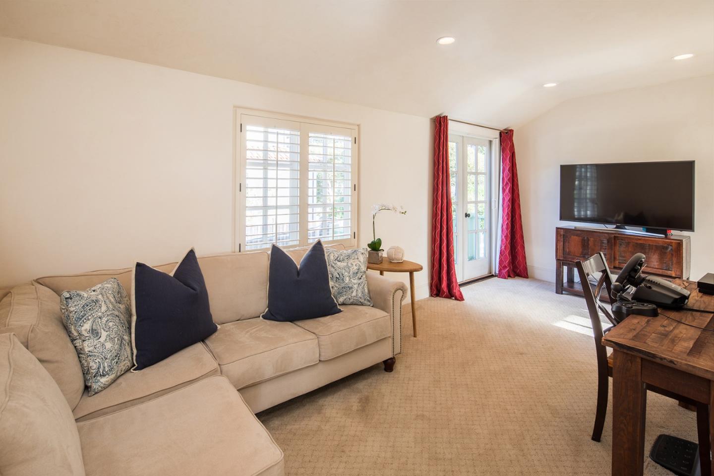 1011 Rodeo Road Pebble Beach, CA 93953 - Photo 35 of 41 a living room with furniture and a flat screen tv