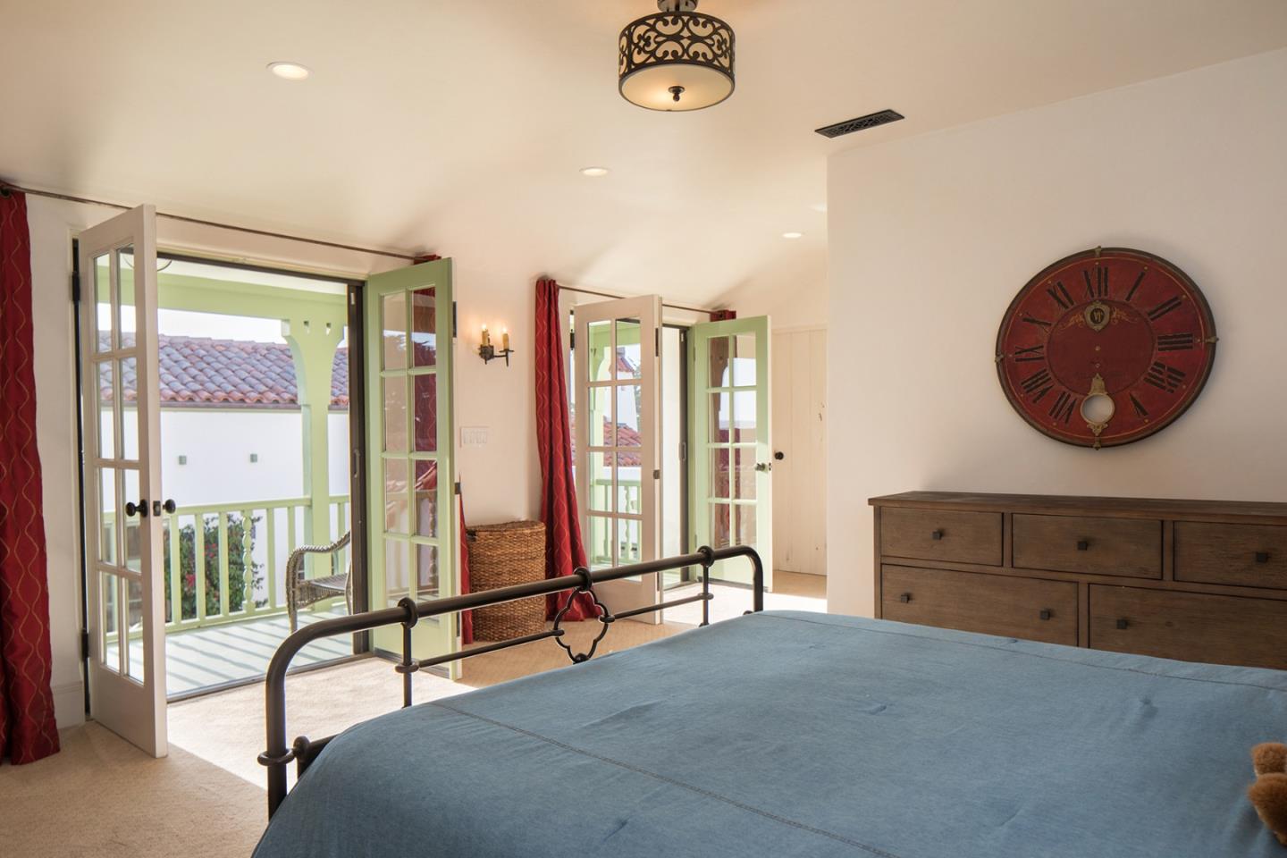 1011 Rodeo Road Pebble Beach, CA 93953 - Photo 36 of 41 a bedroom with a bed and a chandelier