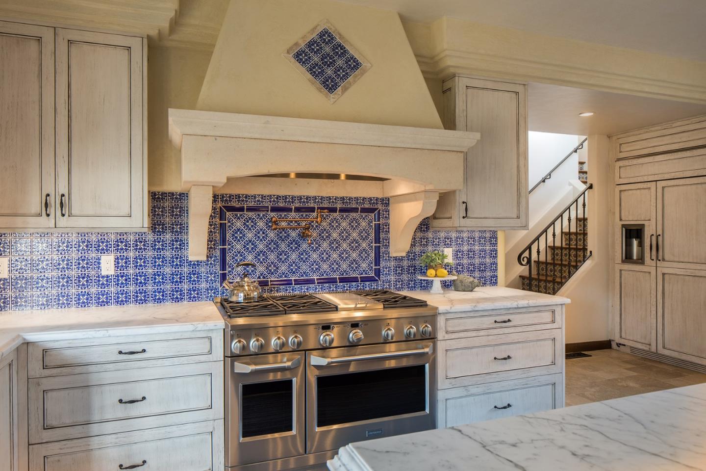 1011 Rodeo Road Pebble Beach, CA 93953 - Photo 6 of 41 a kitchen with a stove and cabinets